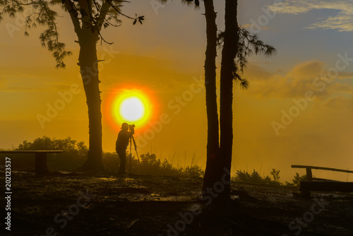 Fototapeta Naklejka Na Ścianę i Meble -  Un-identified photographer shooting photo of beautiful sunrise view