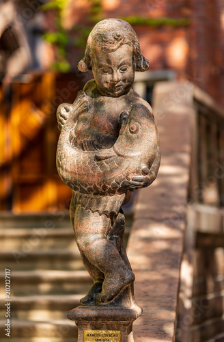 Photography Statue of a boy holding a fish in City Hall or Stadshuset courtyard in Stockholm