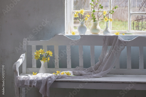 Fototapeta Naklejka Na Ścianę i Meble -  yellow spring flowers in white vintage interior