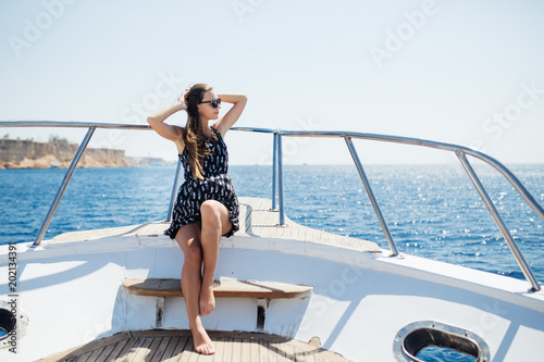 young beautiful woman lying on the deck of a yacht at sea. © F8  \ Suport Ukraine