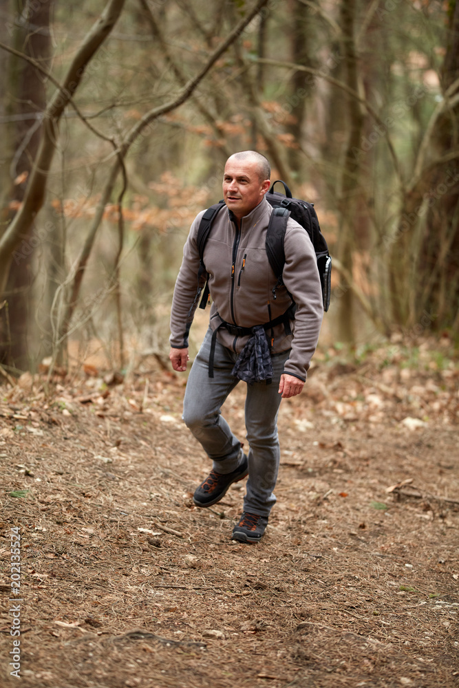 Hiker with backpack on a trail Hiker with backpack on a trail