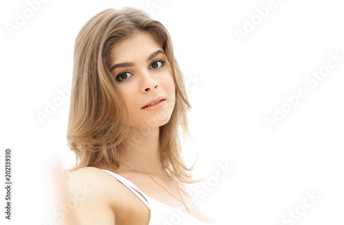 closeup portrait of cute young woman with light make-up.