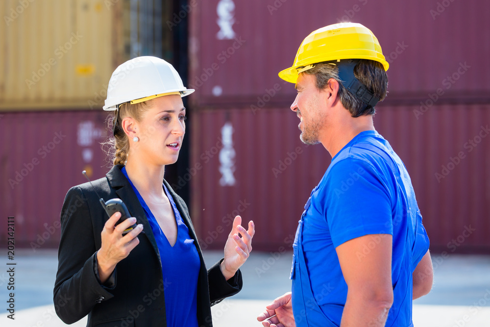 Worker and Manager on container terminal of port discussing Worker and Manager on container terminal of port discussing