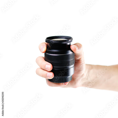 KRASNOYARSK, RUSSIA - April 17, 2018: The hand holds the black lens from the SLR camera. Close up. Isolated on white background