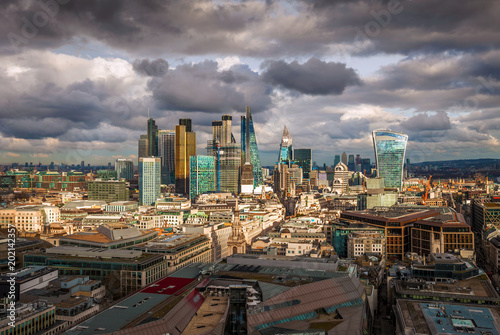 London  England - Panoramic skyline view of Bank and Canary Wharf  central London s leading financial districts with famous skyscrapers at golden hour sunset. Beautiful sky and clouds