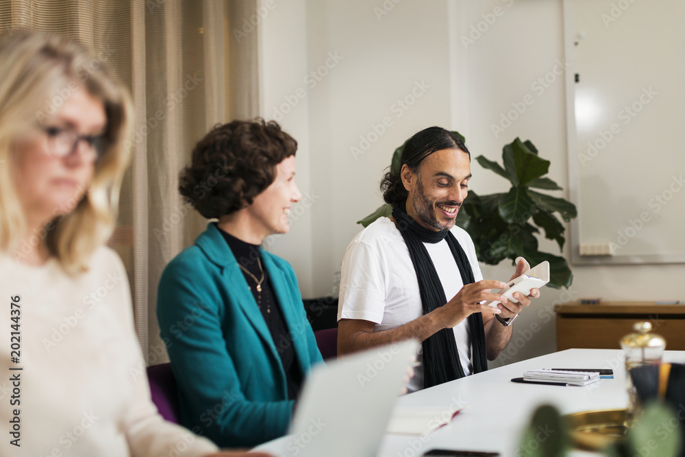 Three people at business meeting Three people at business meeting