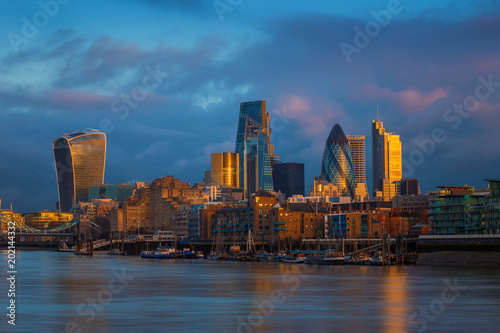 London, England - Skyscrapers of Bank, the leading financial district of London at golden hour with colorful dark sky and clouds © zgphotography