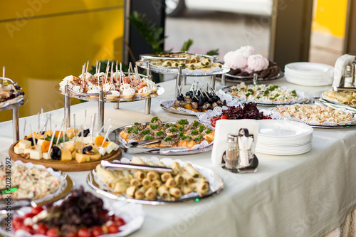 holiday buffet table served by different canape, sandwiches, snacks ready for eating in restaurant