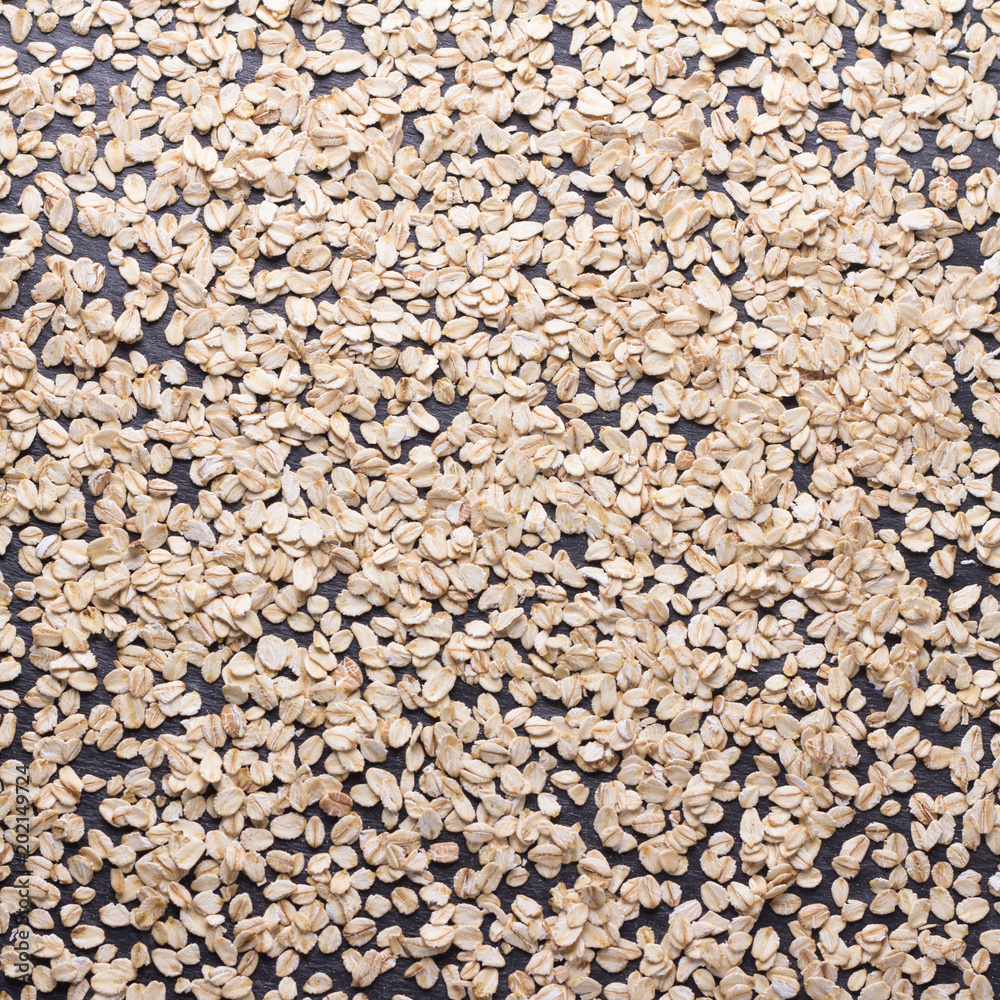 Oat flakes close up, background or texture, square. healthy diet food Oat flakes close up, background or texture, square. healthy diet food