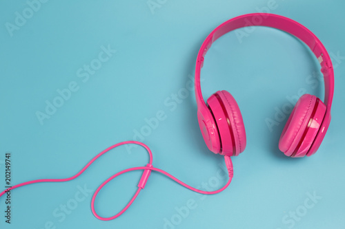 Pink headphones on blue background