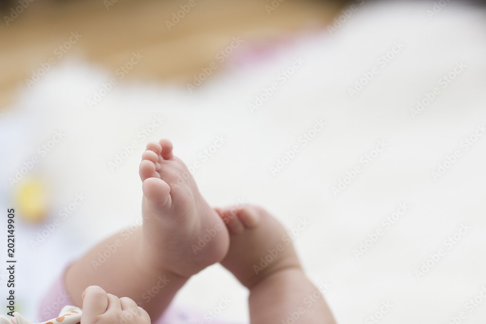 baby feet on white blanket. copy space. selective focus baby feet on white blanket. copy space. selective focus