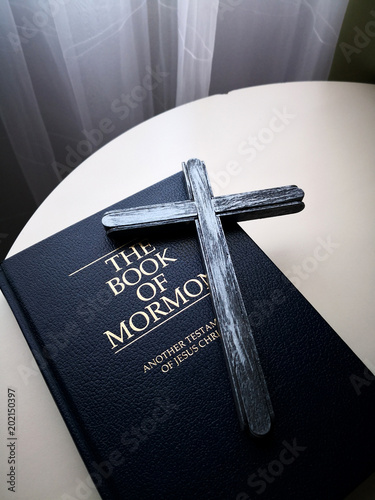 Wood cross and Holy Bible on the table