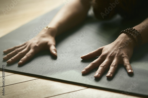 Woman doing yoga on yoga mat photo