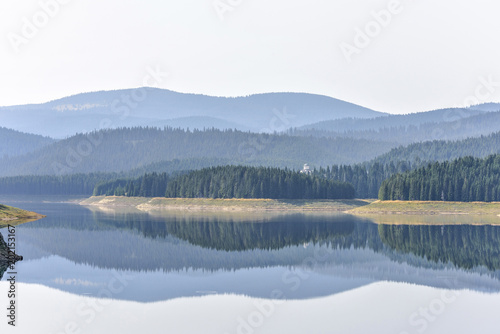 Daylight misty view to Oasa dam lake with mountains