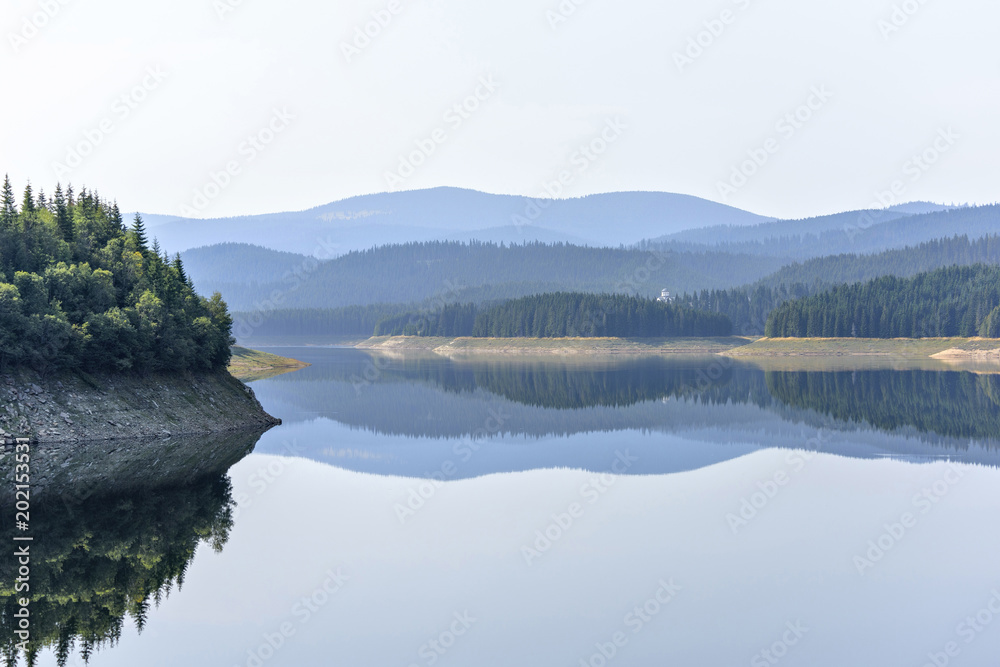Daylight misty view to Oasa dam lake with mountains