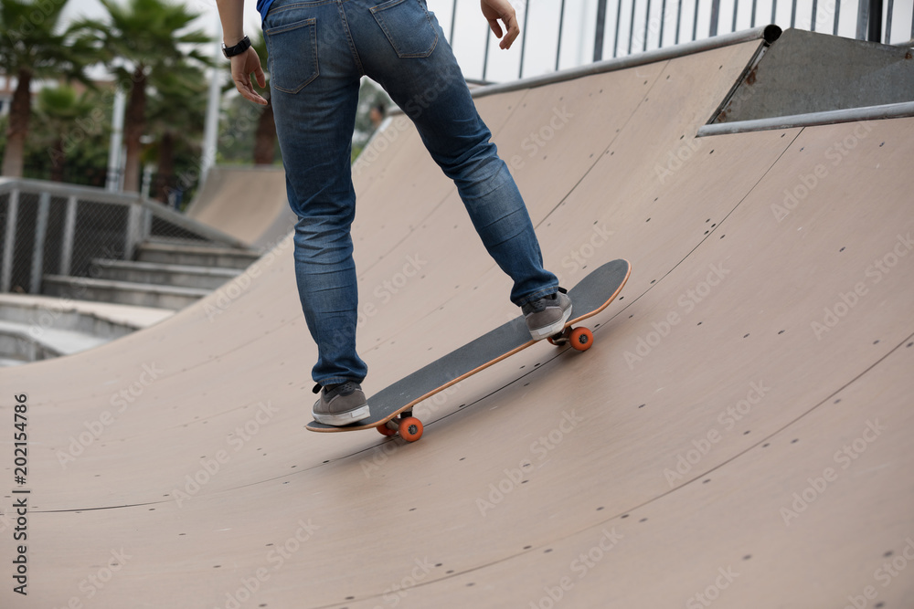 Skateboarder sakteboarding on skatepark ramp Skateboarder sakteboarding on skatepark ramp