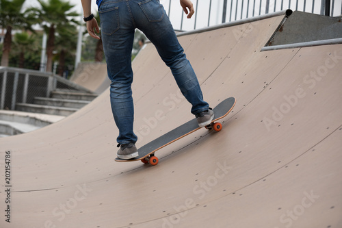 Skateboarder sakteboarding on skatepark ramp