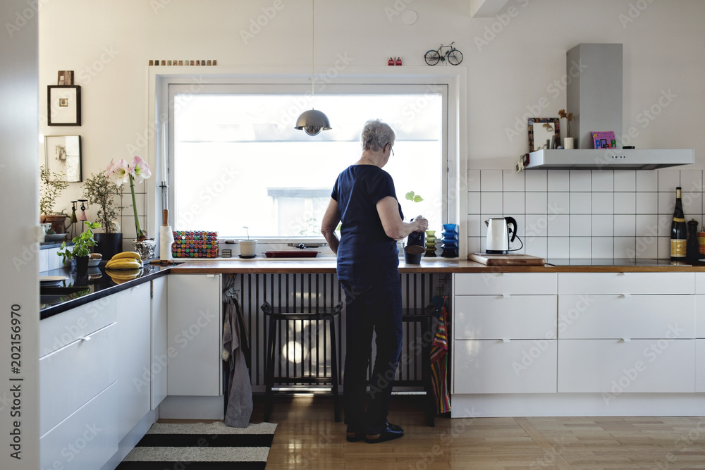 Woman preparing tea in kitchen Woman preparing tea in kitchen