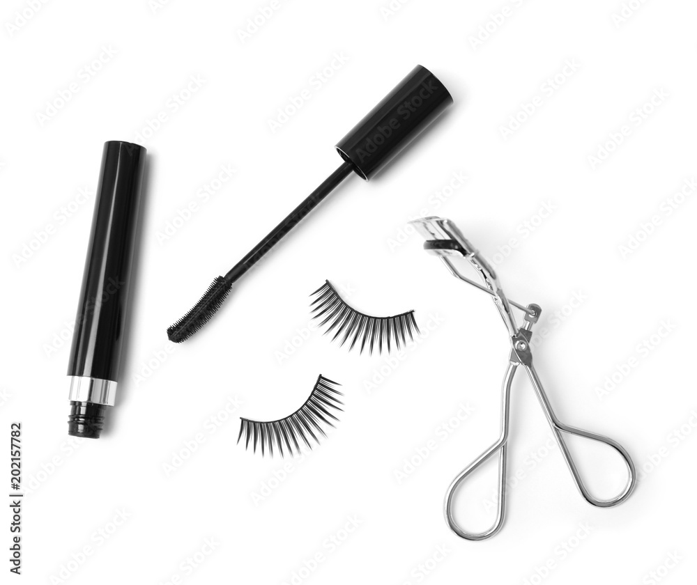 False eyelashes, mascara and curler on white background False eyelashes, mascara and curler on white background