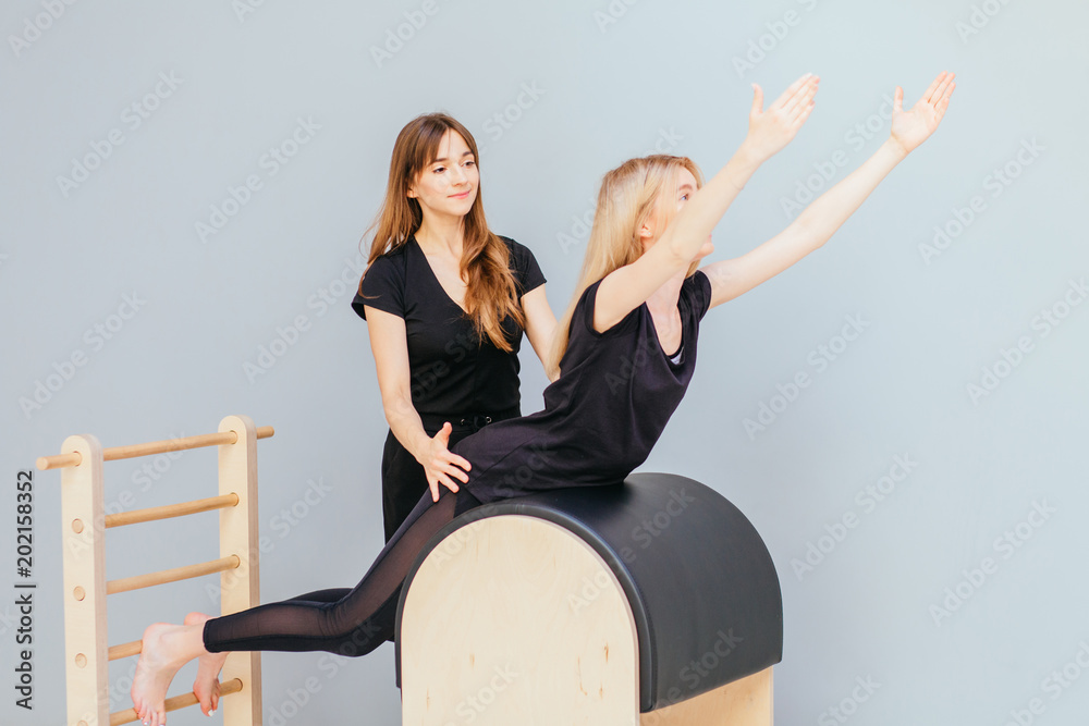 Portrait of Woman Pilates Trainer Doing Exersices on the Ladder