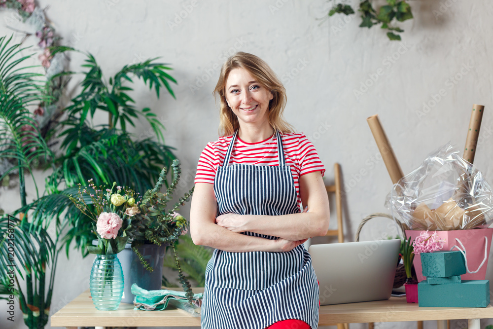 Photo of florist in apron with crossed hands