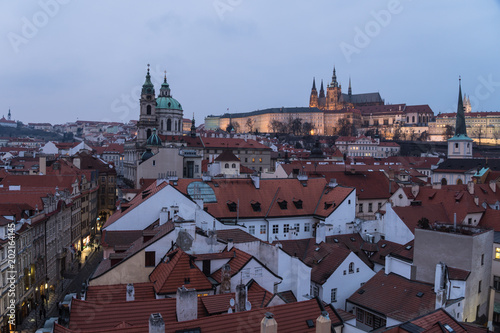 The castle and the Saint Vitus cathedral overlooking Prague old town cityscape in Prague at twilight in Czech Republic capital city.
