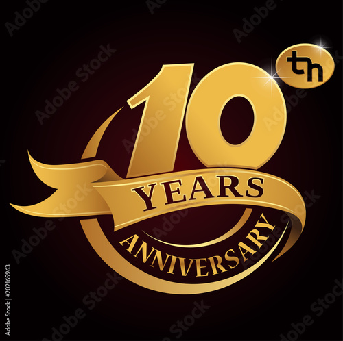 10 years golden anniversary logo celebration with golden ring and ribbon.