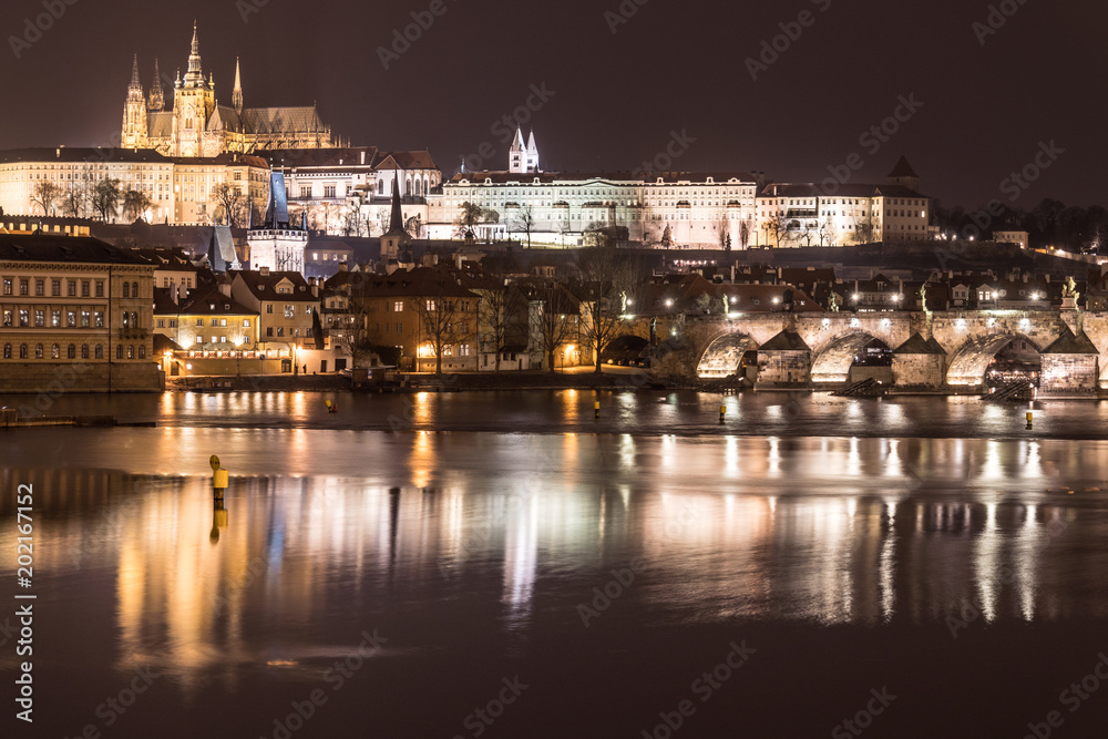 Stunning night view of the Prague castle and the famous Charles bridge over the vltava river in Prague,  Czech Republic capital city.