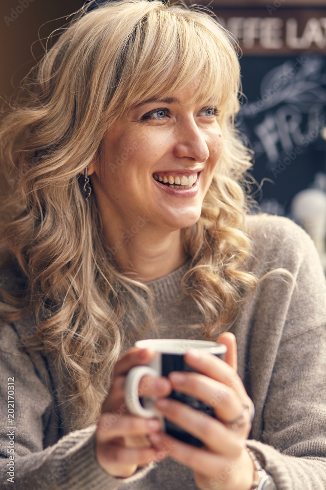 Portrait of a happy woman thinking and looking away