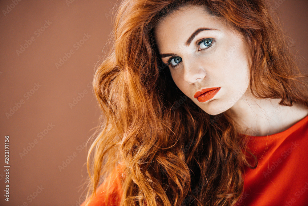 Beautiful young girl isolated on brown background