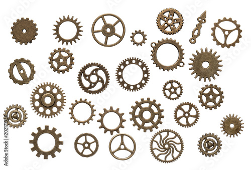 Set of different brass cog wheels isolated on white background photo