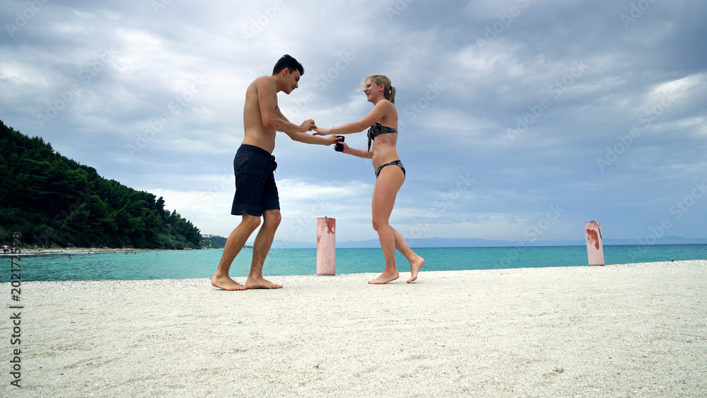 Happy romantic couple dance on beach pier smiling Happy romantic couple dance on beach pier smiling