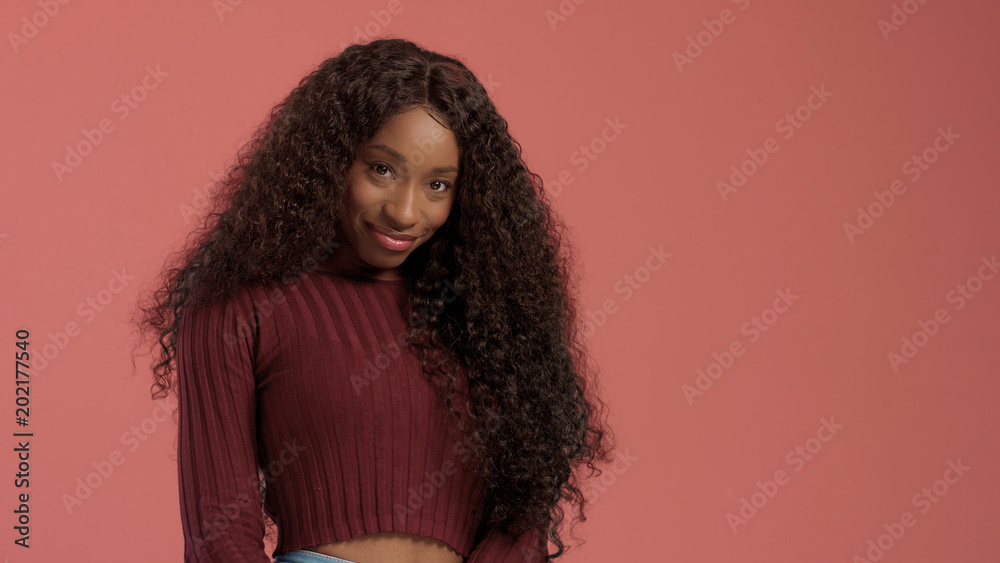 Beauty mixed race african american woman with hair blowed in air smiling at camera Beauty mixed race african american woman with hair blowed in air smiling at camera