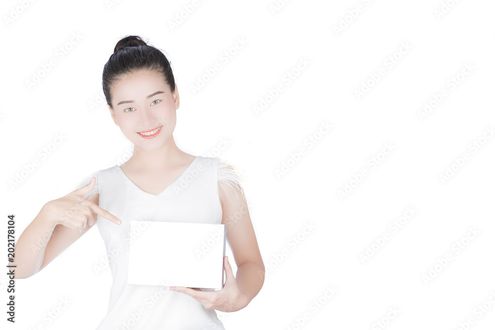 Woman holds the product for presentation. Lady beautiful in white shirt girl advertising your product on blank white sign board. Asian female model isolated on white background. Woman holds the product for presentation. Lady beautiful in white shirt girl advertising your product on blank white sign board. Asian female model isolated on white background.