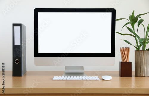 mock up front view blank screen Computer All in one with mouse, keyboard,pencils and tree vase in Modern office