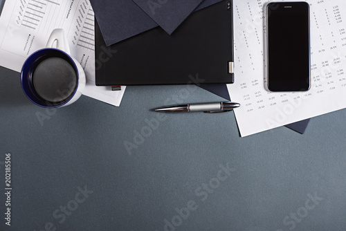 Top view of workplace with financial documents and cup of coffee. Business concept.