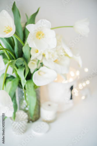 Large bouquet of white spring flowers in a vase, daffodils, tuli