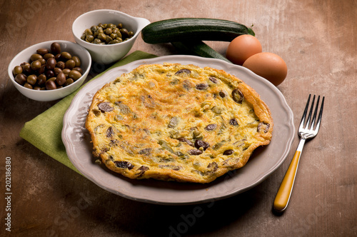omelette with zucchinis black olives and capers