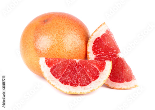 Grapefruit piece isolated on white background. Fresh fruit. With clipping path. Fresh grapefruit with green leaves isolated. photo