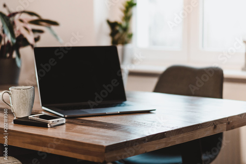 Desk with Laptop and mobile phone close by