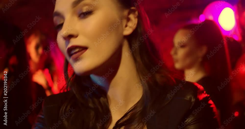 Selfie Time at a Nightclub/Young girl is taking selfie while dancing. She's happy and cheerful. She plays with the camera Selfie Time at a Nightclub/Young girl is taking selfie while dancing. She's happy and cheerful. She plays with the camera