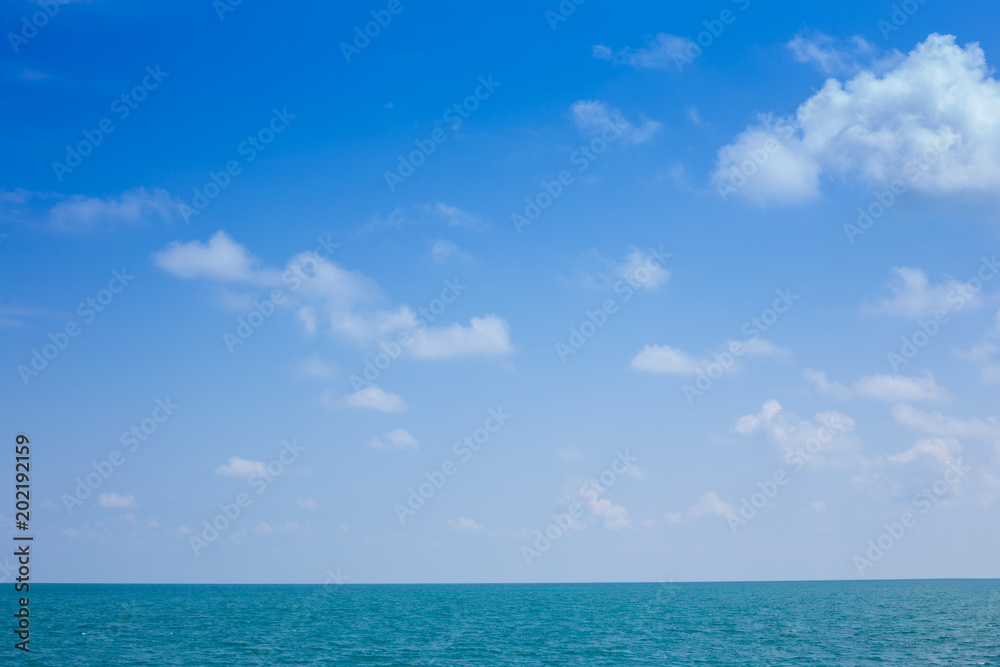 Beautiful white clouds on blue sky over calm sea