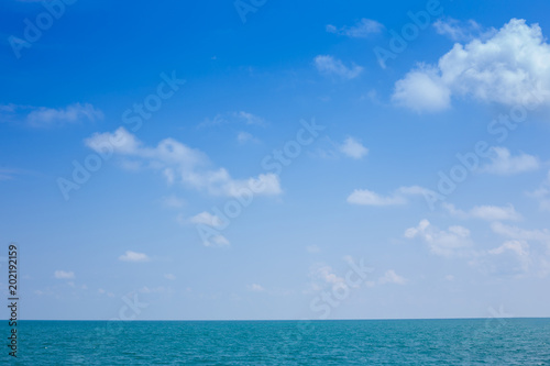 Beautiful white clouds on blue sky over calm sea © chalermchai