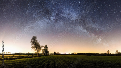 Panorama of a milky way over fields