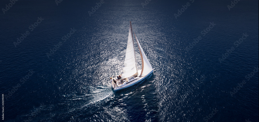 Obraz premium Amazing view to Yacht sailing in open sea at windy day. Drone view - birds eye angle.