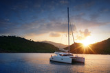 Yacht - Catamaran in the tropical sea at sunset