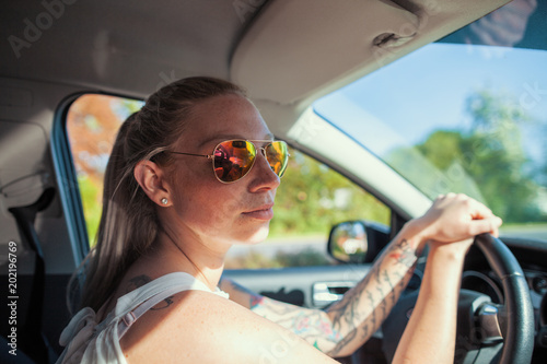 young woman with sunglasses in a car
