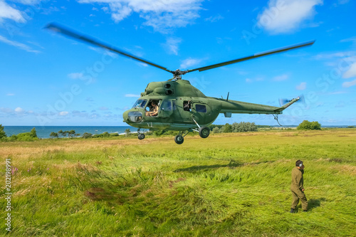 The military sends a helicopter contract up or down the ground. Helicopter landed. Poland