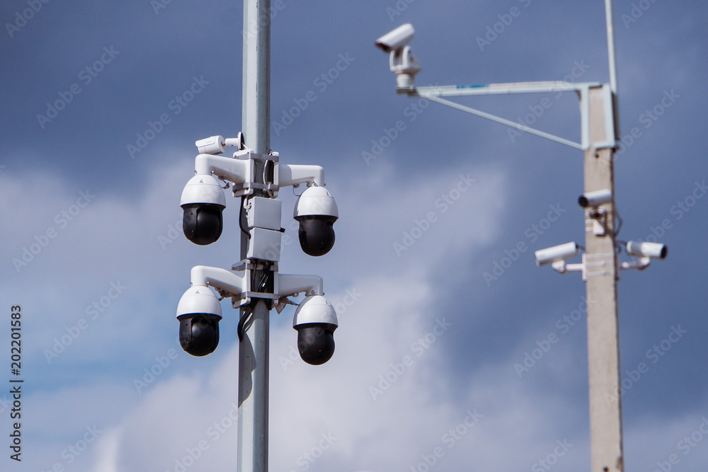 Closeup of four traffic security camera surveillance CCTV on the road in thecity Closeup of four traffic security camera surveillance CCTV on the road in thecity