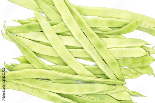 Flat green beans stack top view isolated on white background. photo